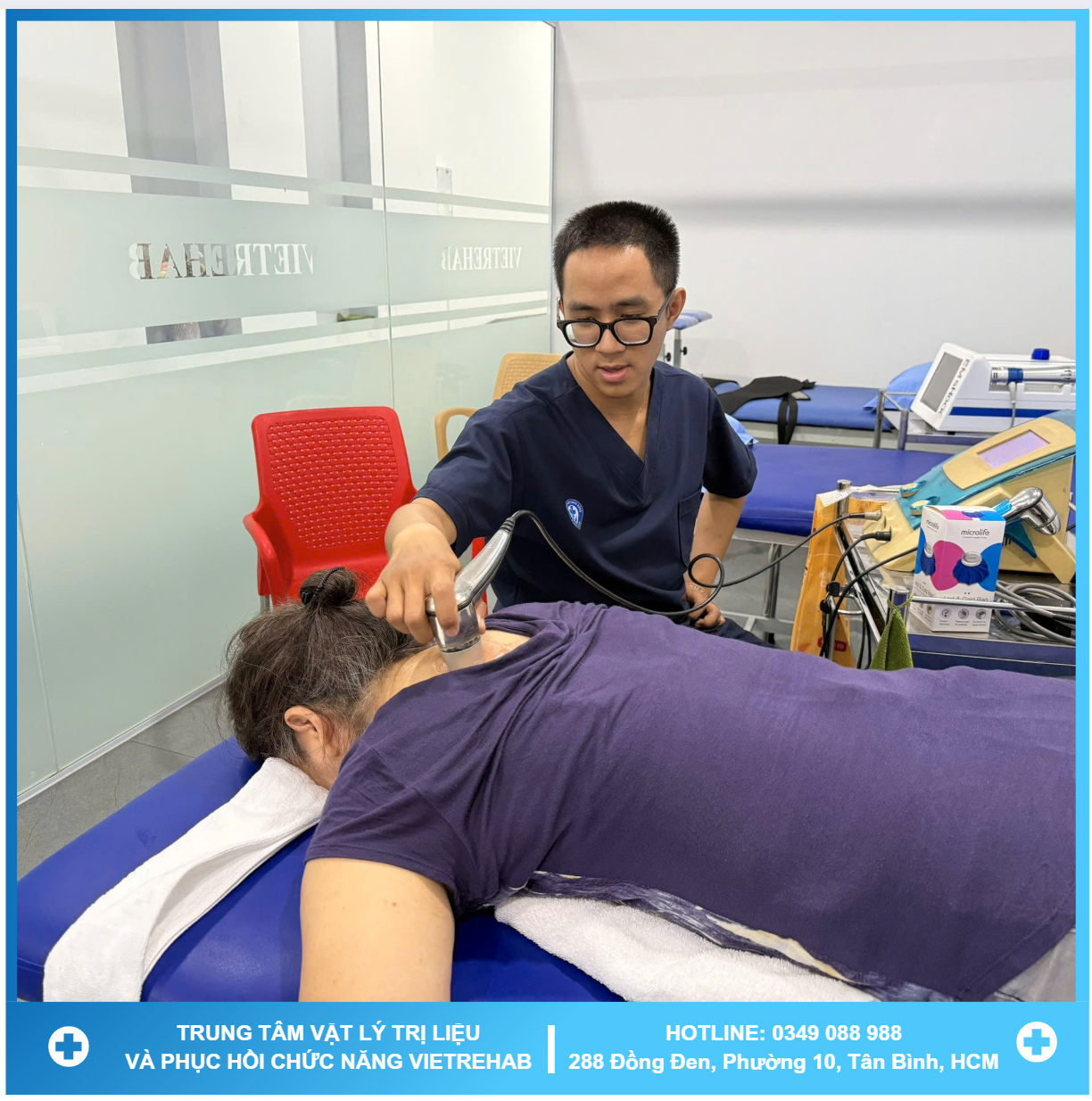 A therapist working with a patient on a rehabilitation machine with greenery in the background